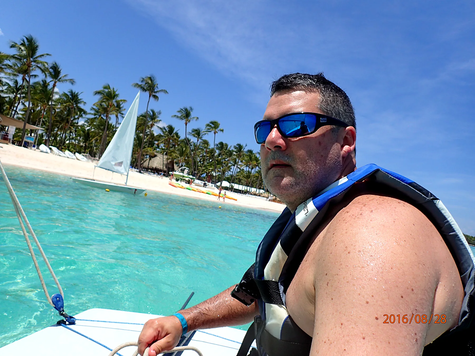 Duque steering a small sailboat